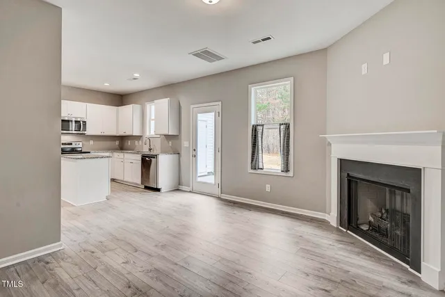 a view of kitchen with granite countertop stainless steel appliances cabinets a sink and a window