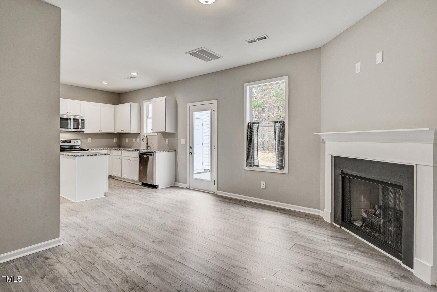67 Stewarts Knob Drive Clayton, NC 27527 - Photo 5 of 26 a view of kitchen with granite countertop stainless steel appliances cabinets a sink and a window