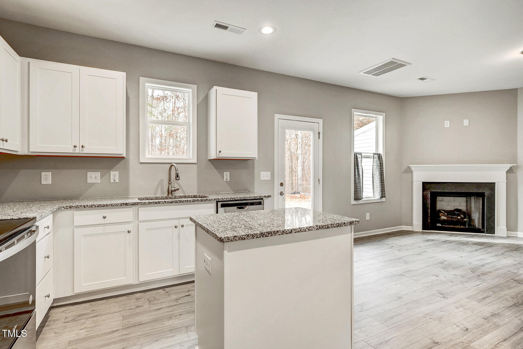 67 Stewarts Knob Drive Clayton, NC 27527 - Photo 7 of 26 a kitchen with granite countertop a stove a sink and a granite counter tops