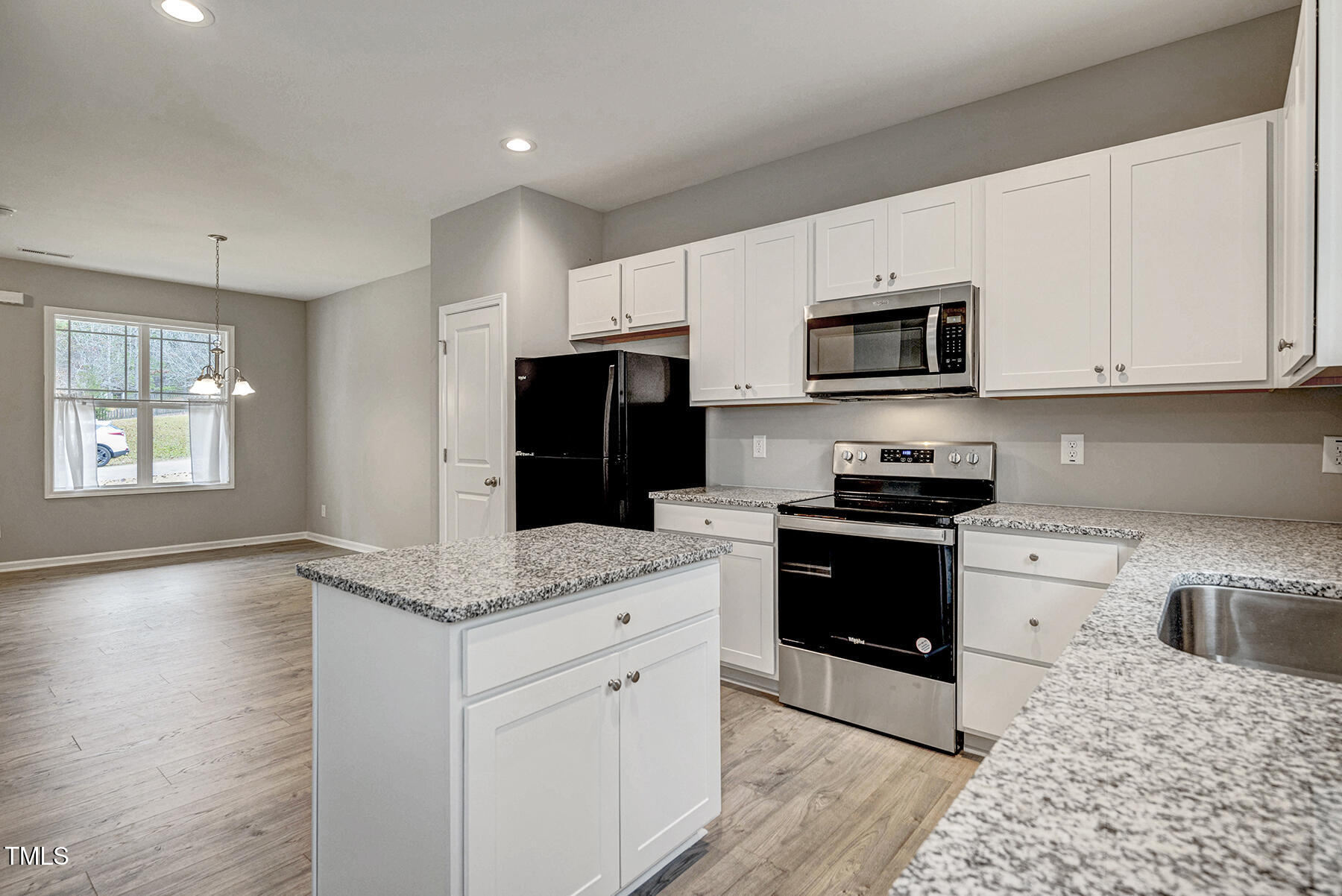 67 Stewarts Knob Drive Clayton, NC 27527 - Photo 9 of 26 a kitchen with stainless steel appliances granite countertop a stove a sink and a microwave
