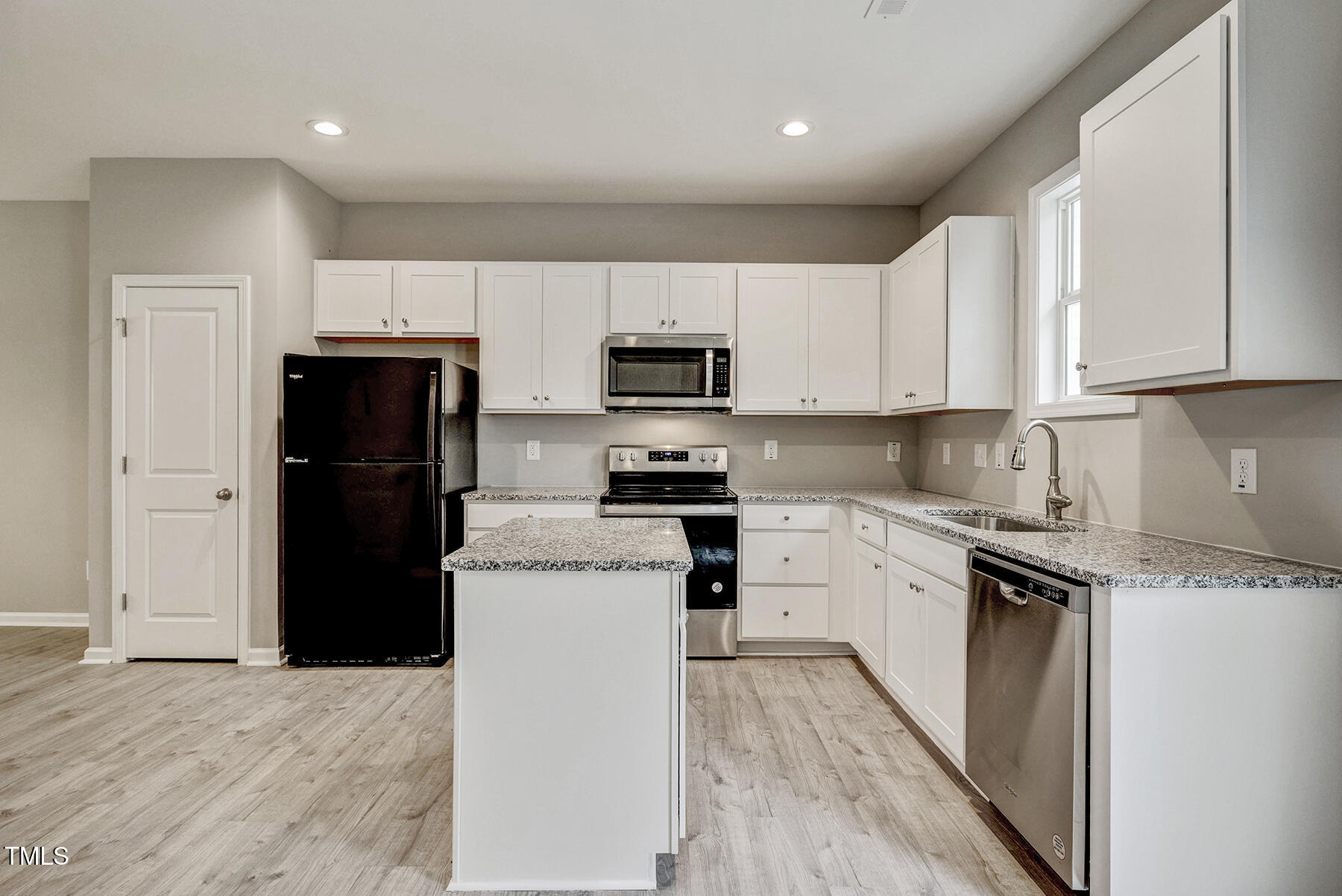 67 Stewarts Knob Drive Clayton, NC 27527 - Photo 10 of 26 a kitchen with a refrigerator a stove top oven and cabinets