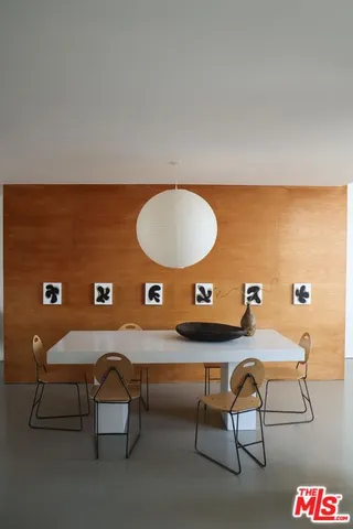 a view of a workspace room with table and chairs