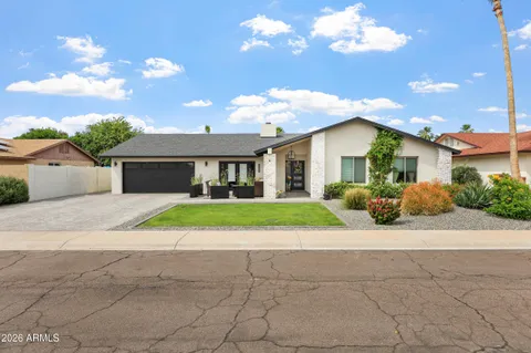 a front view of a house with a yard and a garage