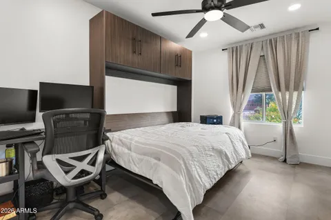 a bedroom with a bed closet and flat screen tv