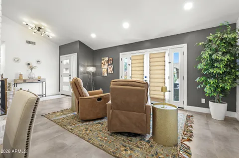 a living room with furniture and a potted plant