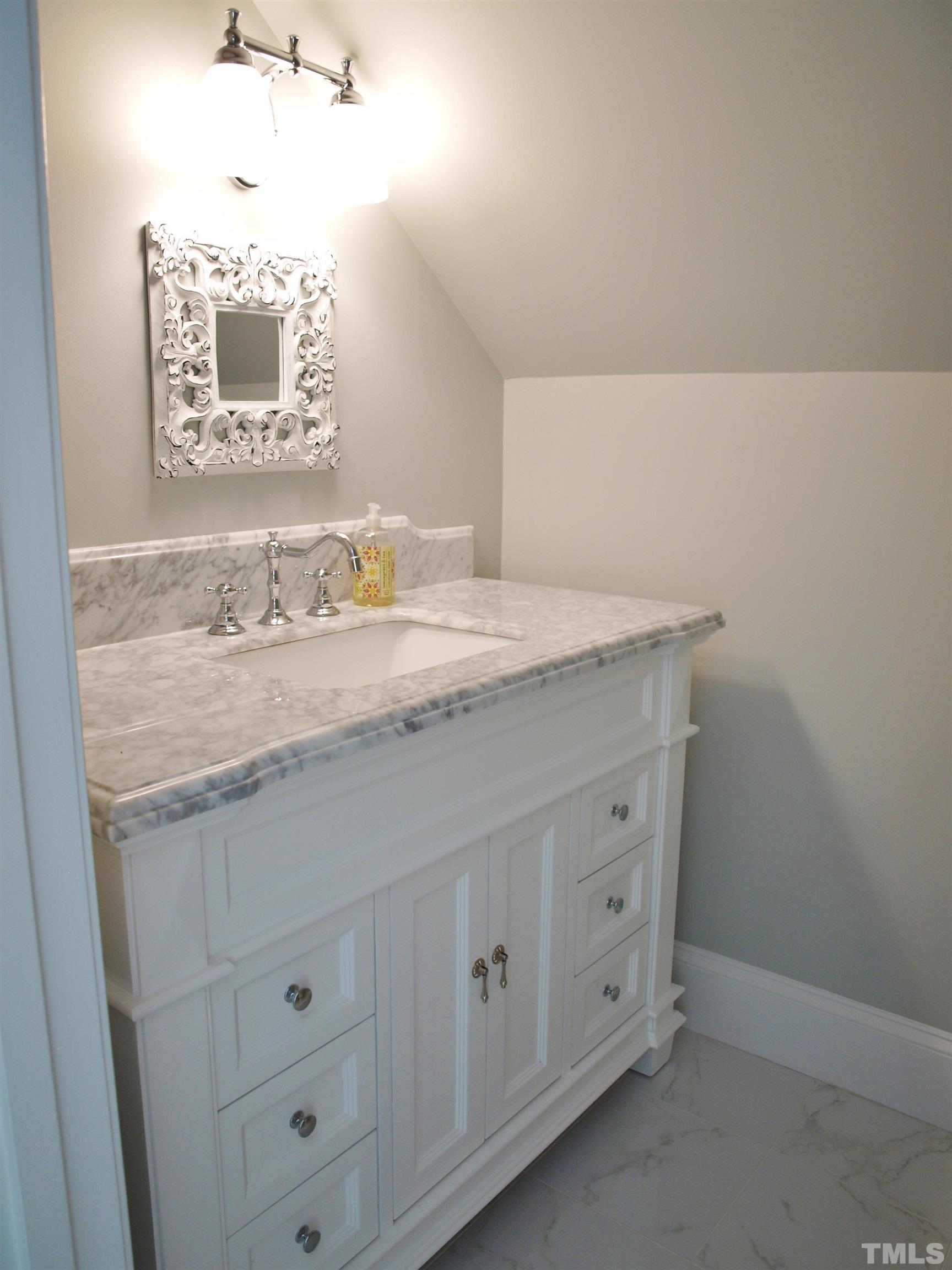 2905 Bolo Trail Raleigh, NC 27615 - Photo 20 of 25 a bathroom with a granite countertop sink and a mirror