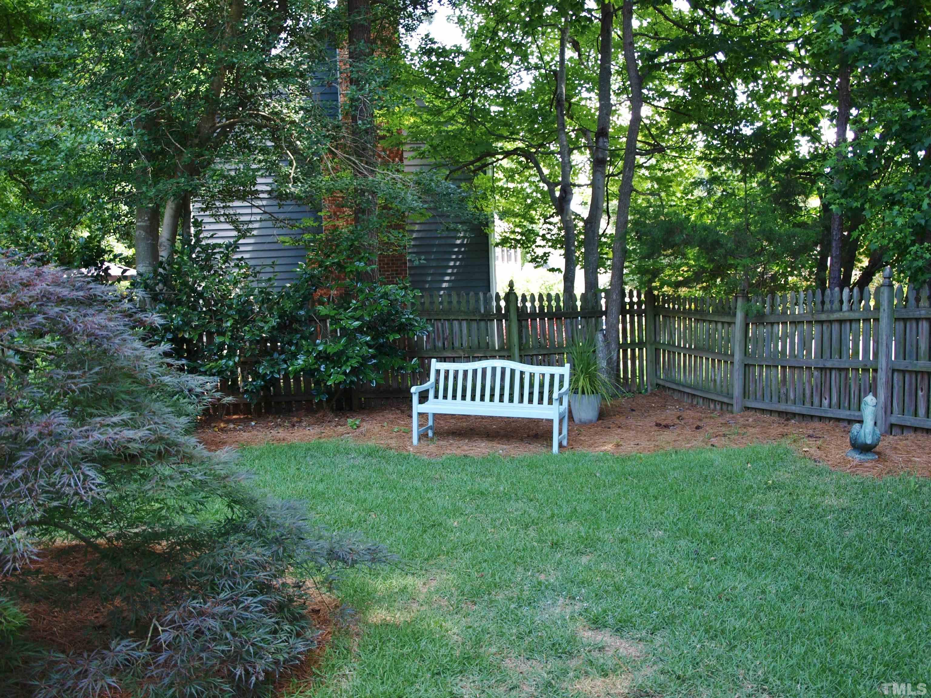 2905 Bolo Trail Raleigh, NC 27615 - Photo 24 of 25 a view of a deck with a large trees and wooden fence