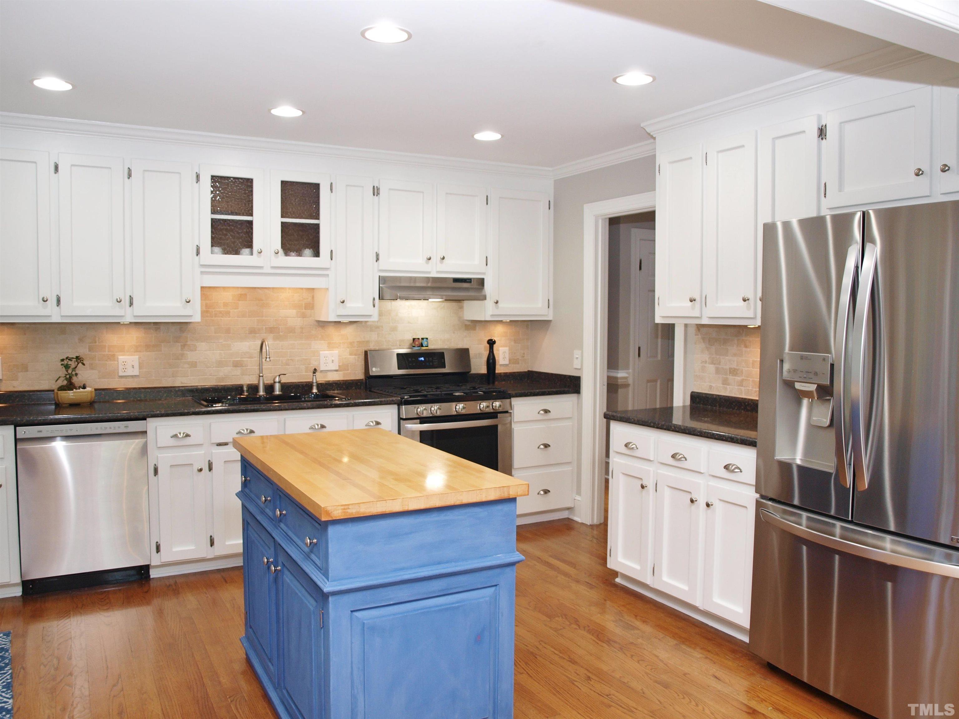 2905 Bolo Trail Raleigh, NC 27615 - Photo 9 of 25 a kitchen with granite countertop stainless steel appliances and wooden cabinets