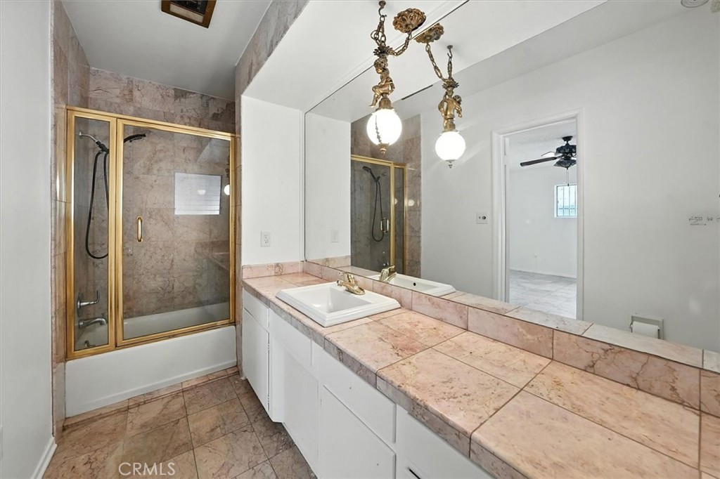 9953 La Tuna Canyon Road Sun Valley, CA 91352 - Photo 14 of 32 a spacious bathroom with a granite countertop sink a mirror and a shower
