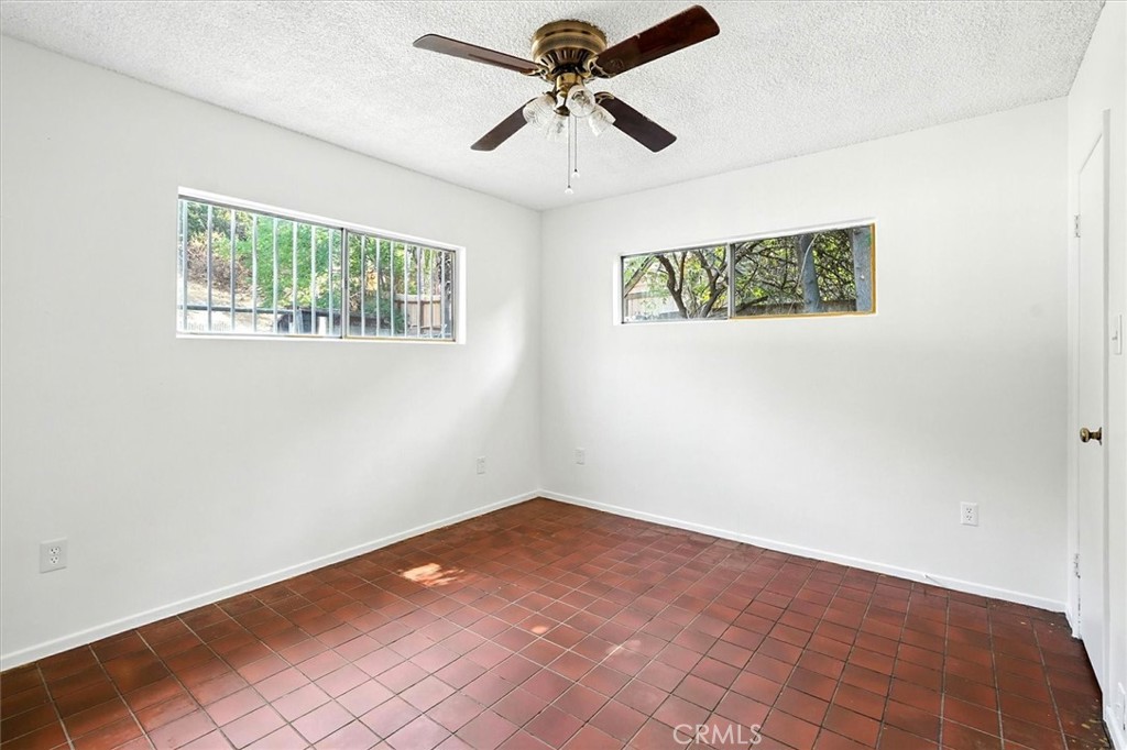 9953 La Tuna Canyon Road Sun Valley, CA 91352 - Photo 17 of 32 an empty room with a window and a ceiling fan