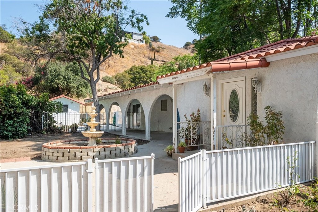 9953 La Tuna Canyon Road Sun Valley, CA 91352 - Photo 5 of 32 a view of a white house with wooden fence