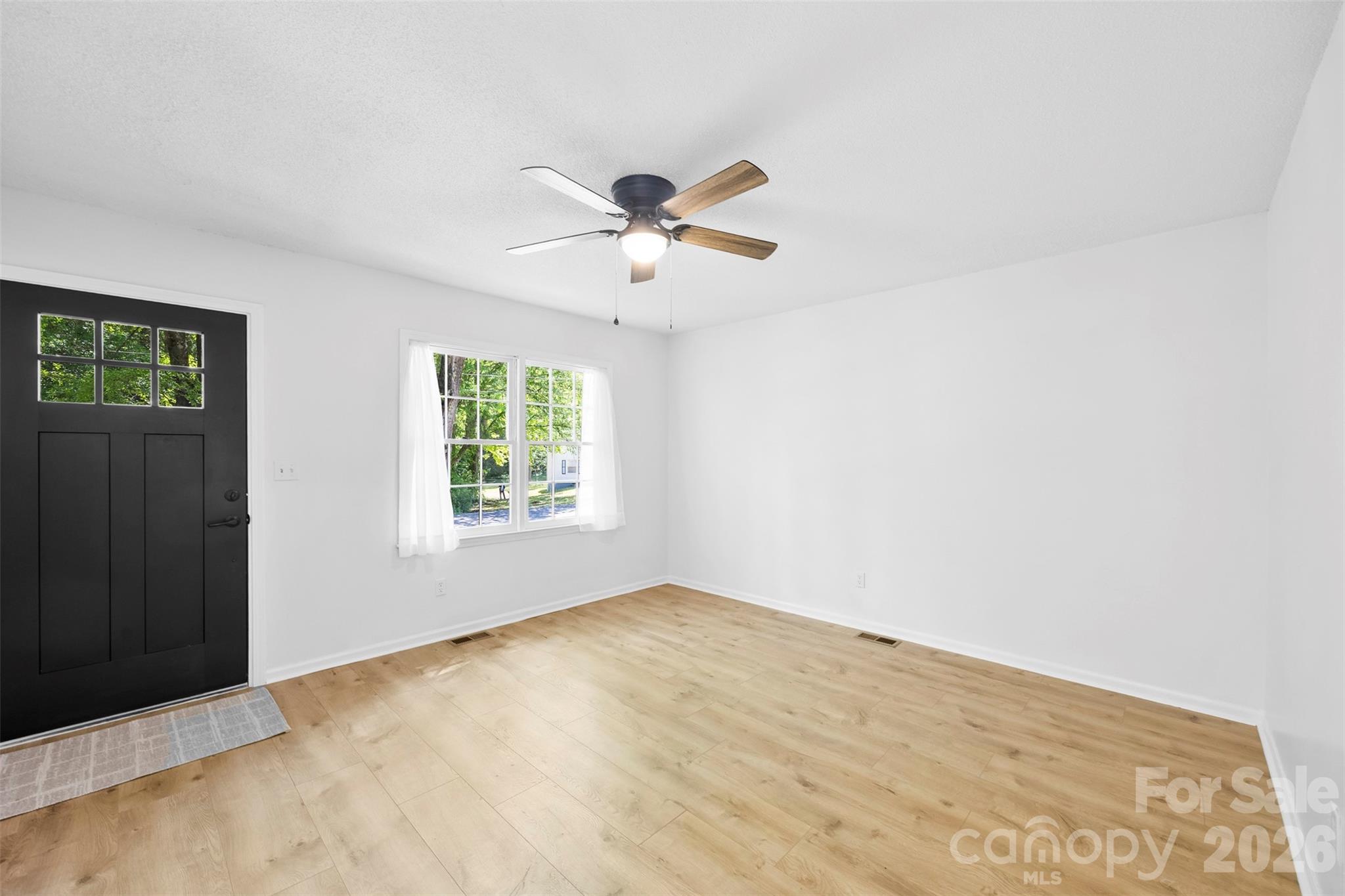 509 California Circle York, SC 29745 - Photo 5 of 26 a view of a big room with windows and chandelier fan