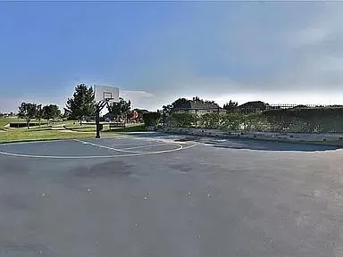 a view of a backyard with wooden fence