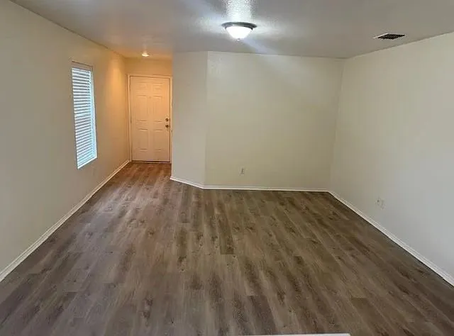 a kitchen with a sink a microwave and cabinets