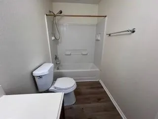 a view of wooden floor in an empty room with a window