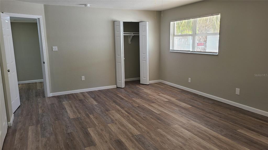 4611 West Villa Rosa Street Tampa, FL 33611 - Photo 13 of 22 an empty room with wooden floor and windows
