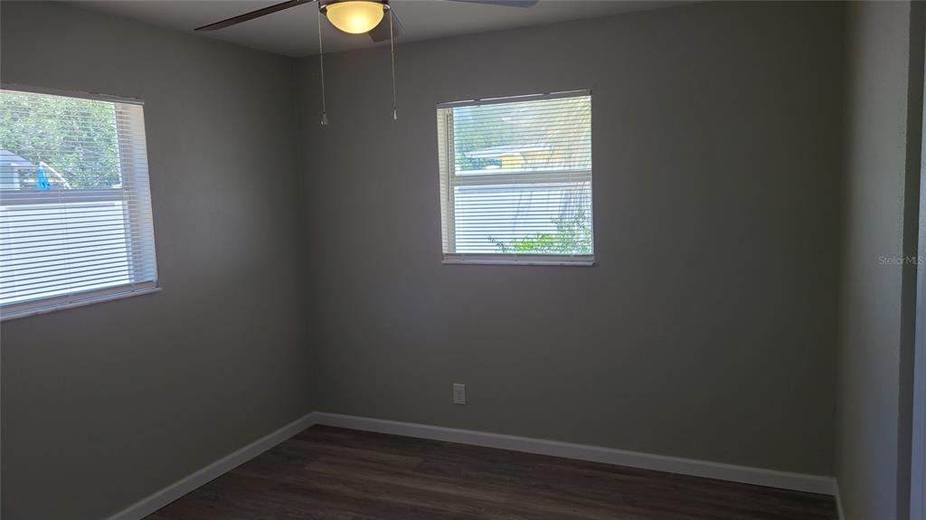 4611 West Villa Rosa Street Tampa, FL 33611 - Photo 15 of 22 an empty room with a window and wooden floor