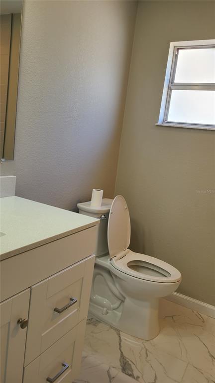 4611 West Villa Rosa Street Tampa, FL 33611 - Photo 17 of 22 a bathroom with a toilet sink and mirror