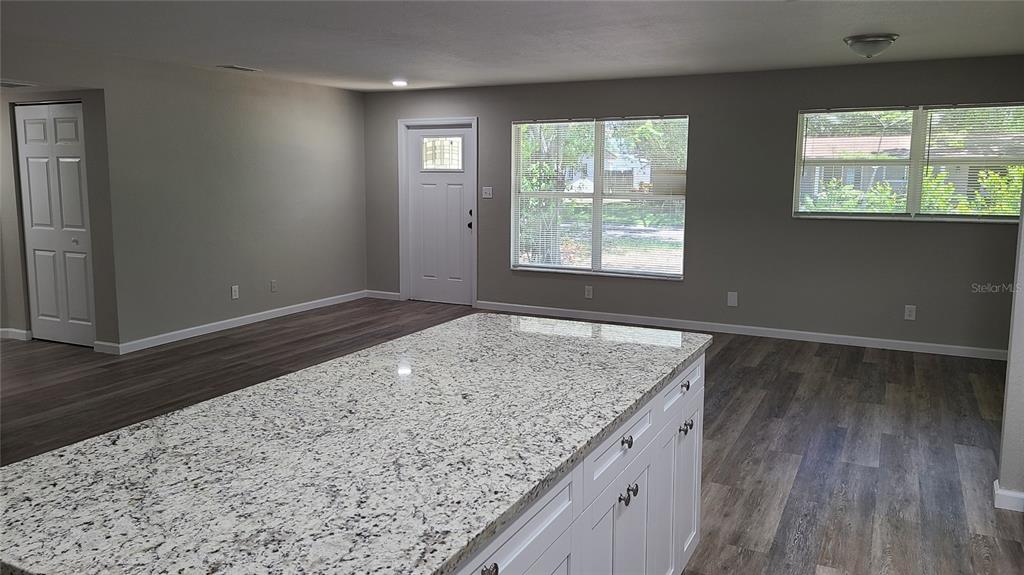 4611 West Villa Rosa Street Tampa, FL 33611 - Photo 8 of 22 an empty room with wooden floor and windows