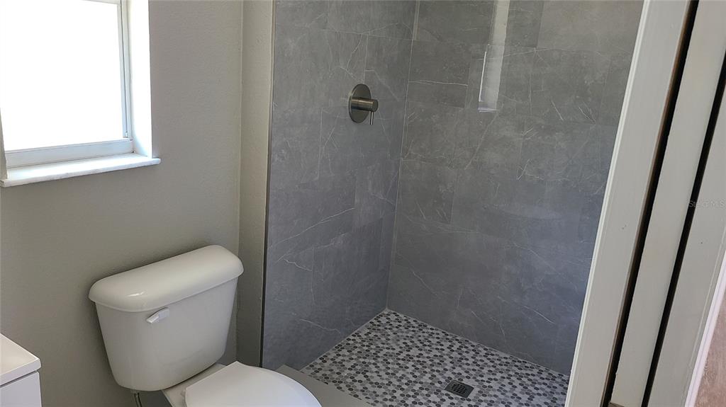 4611 West Villa Rosa Street Tampa, FL 33611 - Photo 10 of 22 a white toilet sitting next to a shower