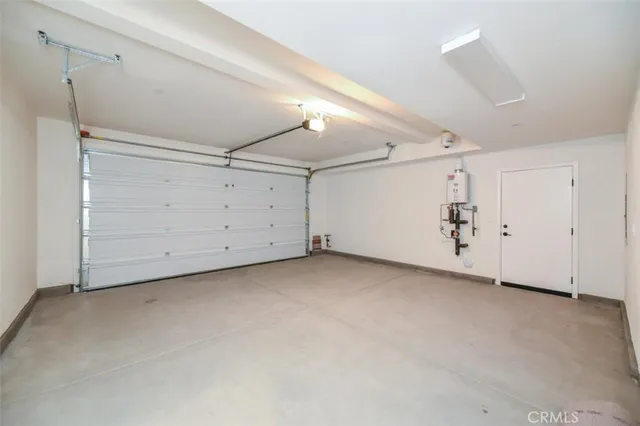 a bathroom with a granite countertop sink and a refrigerator