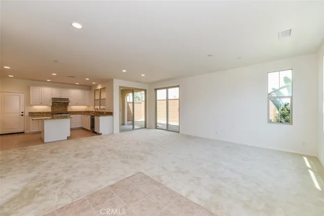 a view of a livingroom with a kitchen and a sink