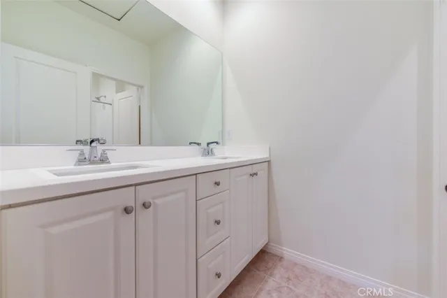 a bathroom with a double vanity sink and mirror