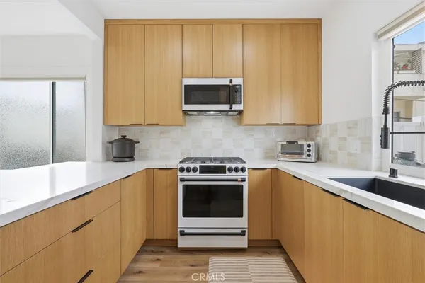 a kitchen with a sink stove and microwave