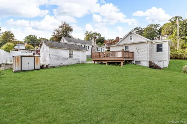 a view of a house with a yard and sitting area