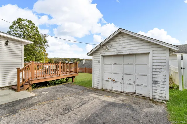 a view of a house with a yard and wooden fence
