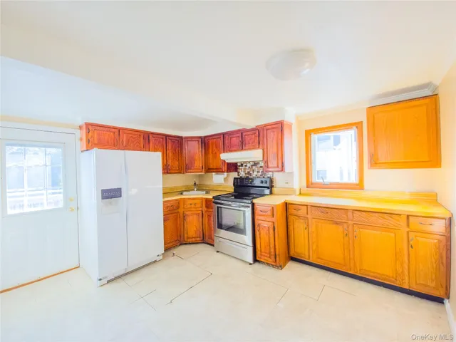 a kitchen with cabinets a sink and appliances