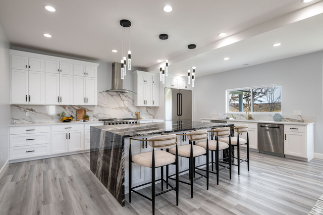 476 Spring Drive Toquerville, UT 84774 - Photo 15 of 95 Kitchen featuring dark stone countertops, white cabinets, a breakfast bar, and light wood-style floors