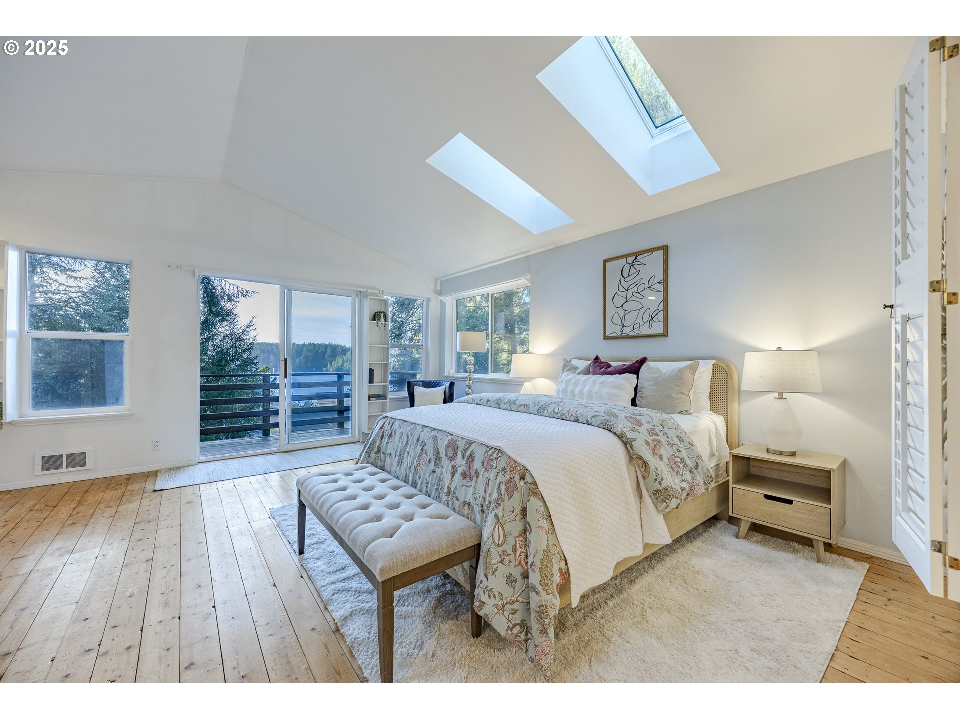 83694 Rio Road Florence, OR 97439 - Photo 24 of 45 a spacious bedroom with a bed a dresser and wooden floor