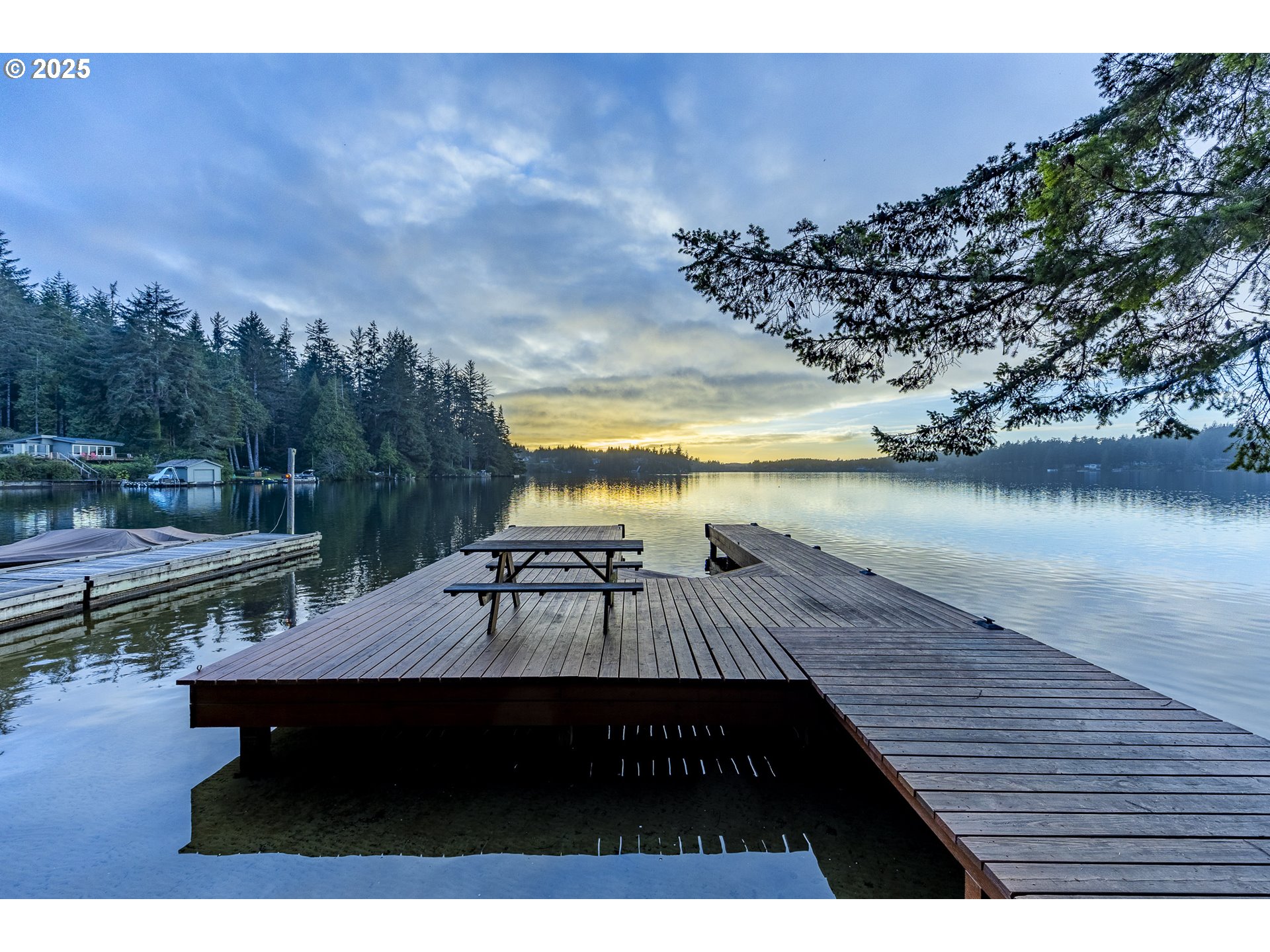 83694 Rio Road Florence, OR 97439 - Photo 40 of 45 a view of a roof deck with table and chairs with wooden floor and fence