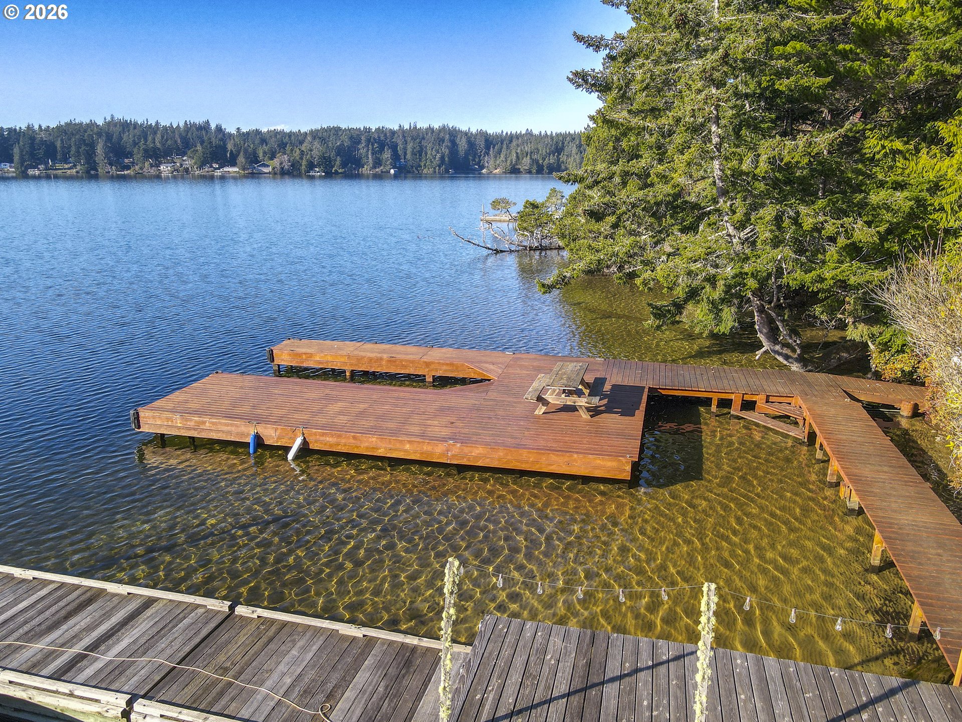 83694 Rio Road Florence, OR 97439 - Photo 43 of 45 a wooden bench sitting next to a lake