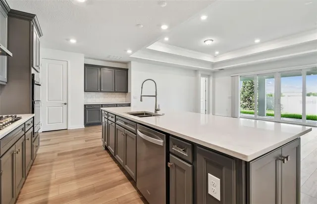 a kitchen with kitchen island a sink stove and refrigerator