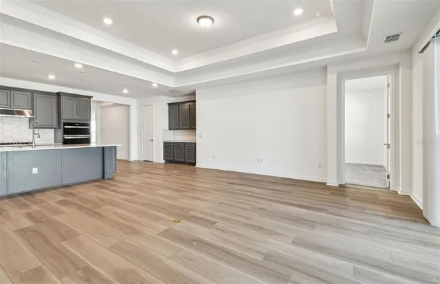 a view of a kitchen with a sink and a refrigerator