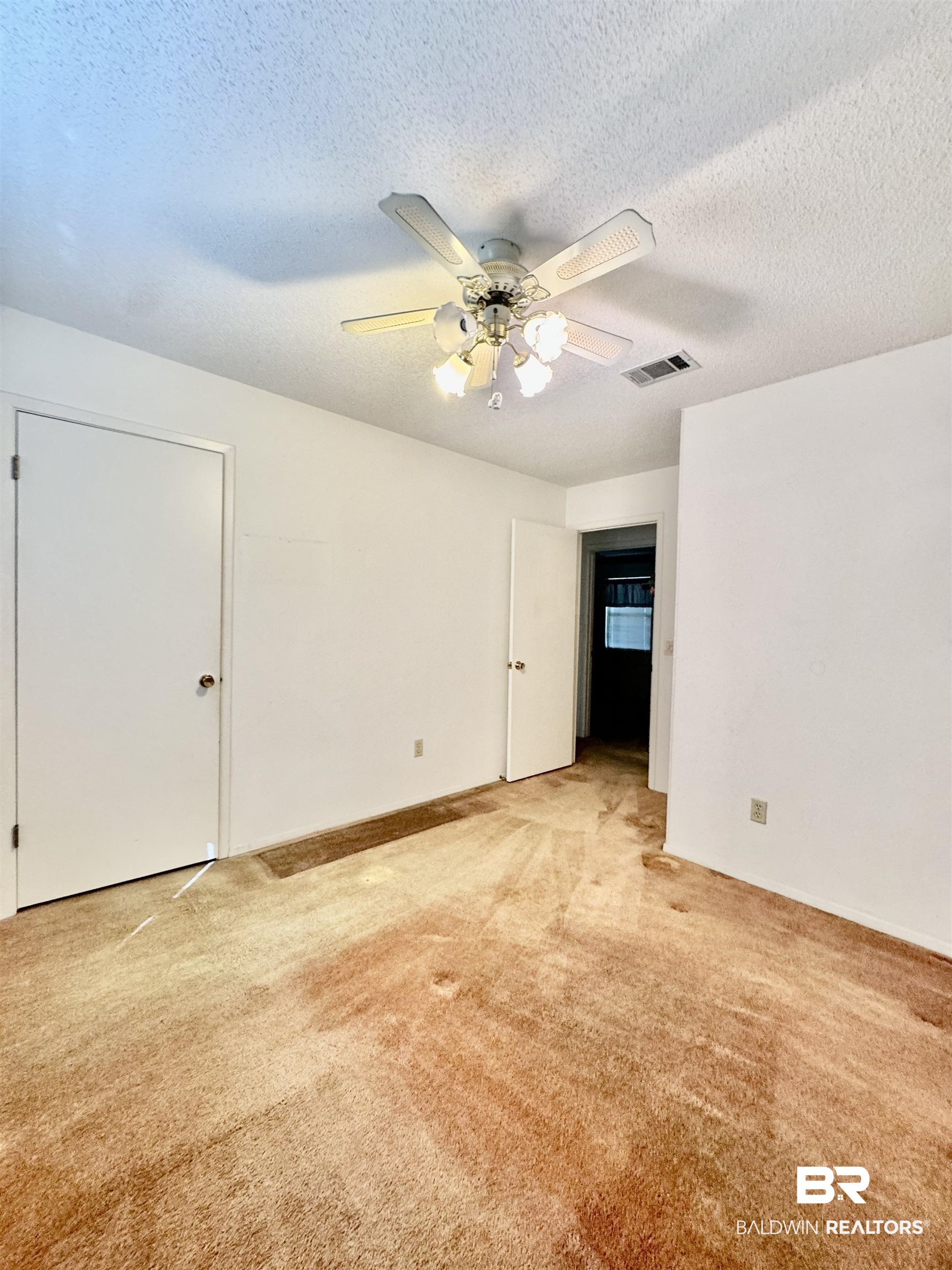 512 Deborah Court Foley, AL 36535 - Photo 6 of 23 Unfurnished room with a textured ceiling, light carpet, and ceiling fan