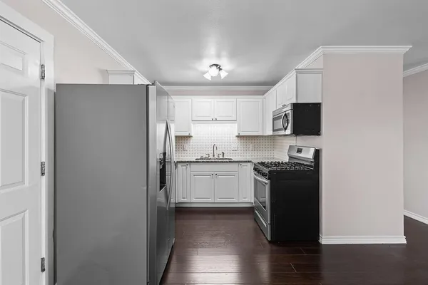 a kitchen with a refrigerator stove and sink