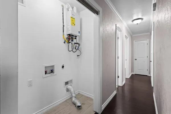 a view of a hallway with wooden floor
