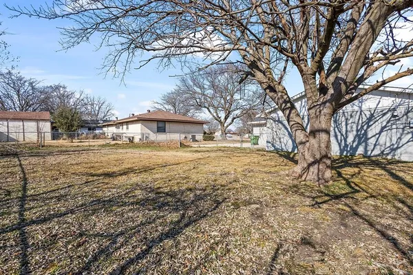 a view of yard covered with snow in front of house