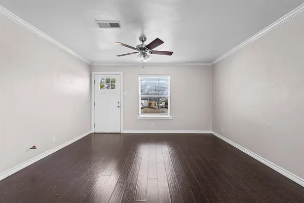 wooden floor in an empty room with a window