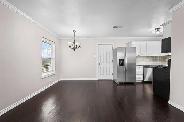 a view of empty room with wooden floor and fireplace