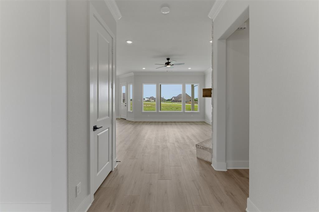 2204 Continent Court Krum, TX 76249 - Photo 5 of 28 Expansive room featuring light wood-finish flooring, recessed lighting, and a ceiling fan