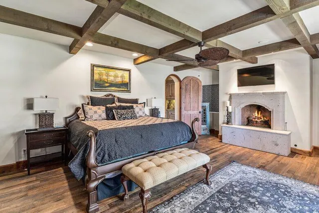 a bedroom with a bed a couch and large window