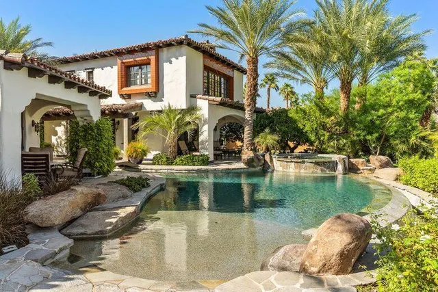 a view of a house with pool and sitting area