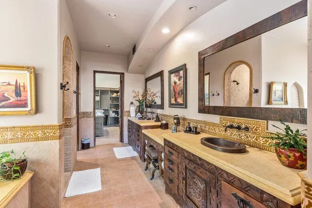 a bedroom with a large bed and a potted plant