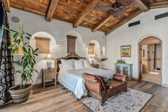 a bedroom with a bed and a fireplace