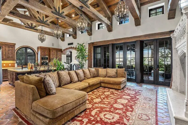 a living room with furniture a potted plant and a fireplace