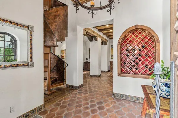 a view of a house with a yard and potted plants
